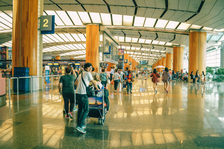 Penumpang Garuda Indonesia melakukan check-in bagasi di bandara.